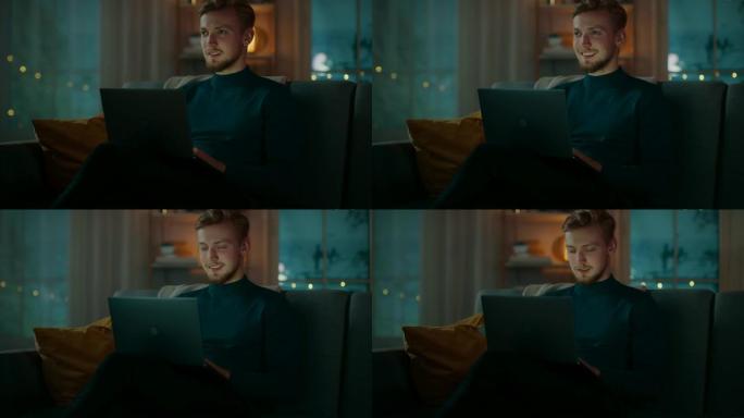 晚上，英俊的年轻人坐在沙发上，坐在笔记本电脑上工作。