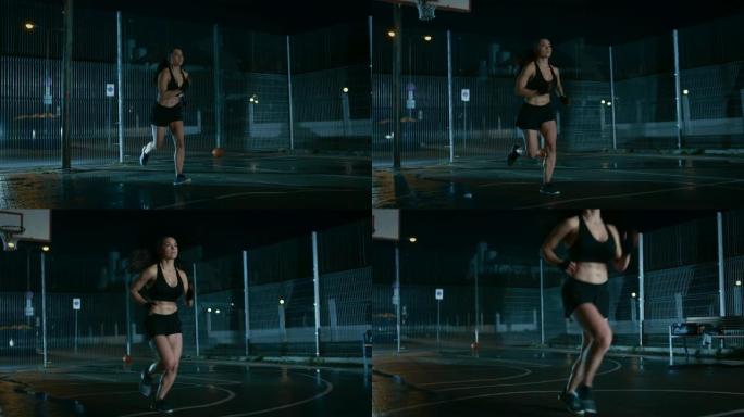 美丽的精力充沛的健身女孩正在一个有围栏的室外篮球场里冲刺。她晚上下雨后在居民区跑步。