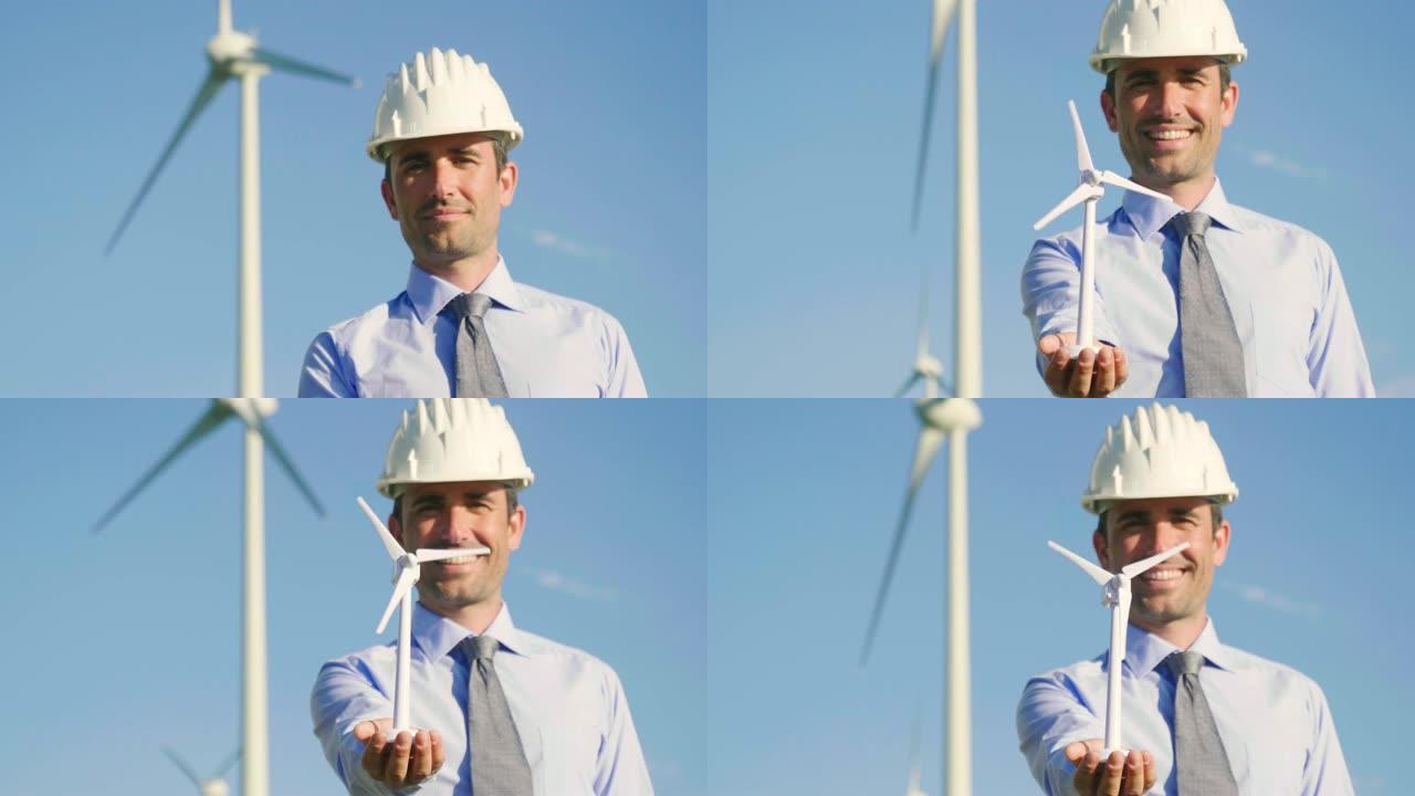 一个风电场的工程师展示了一个微型风力涡轮机的微笑。