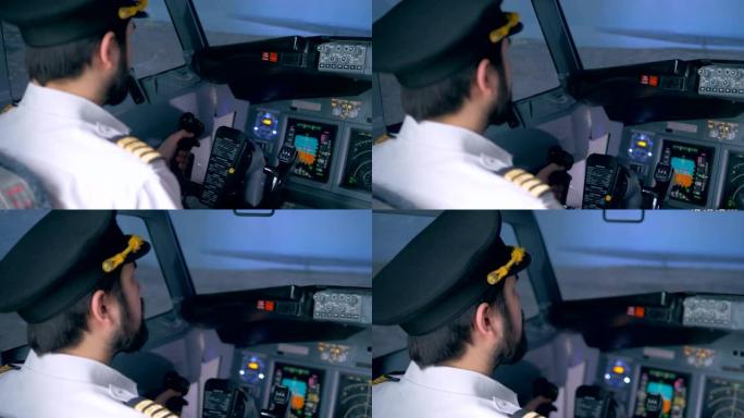 管理飞机的男性飞行员的后视图