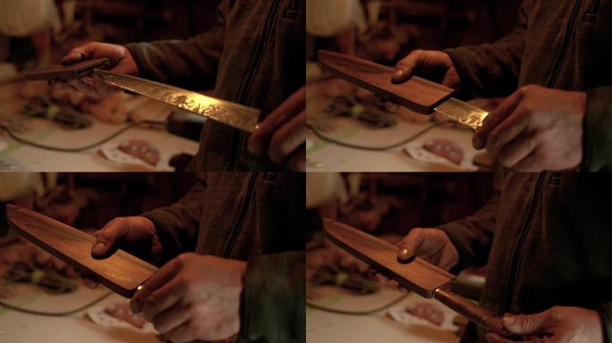 特写: Bladesmith将完成的传统刀插入木制护套。