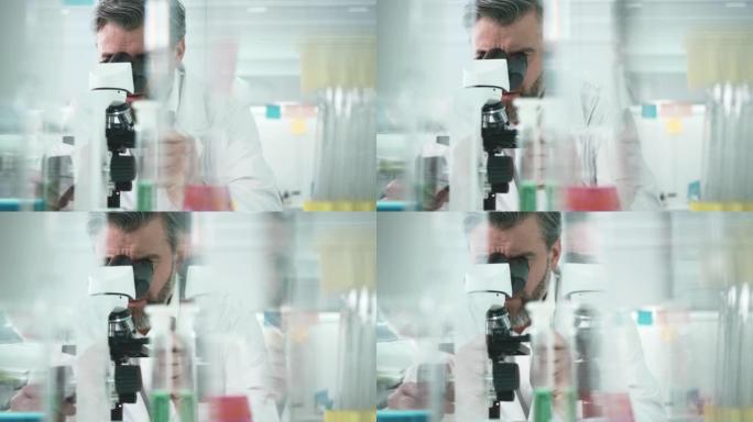 科学主义者正在通过显微镜观察
