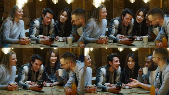 微笑的朋友在咖啡馆喝咖啡和玩手机的慢动作