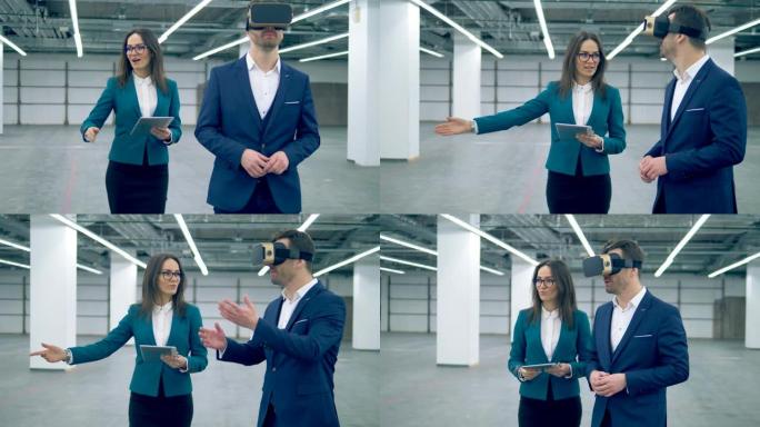 两名房地产经纪人在房间里散步时使用VR眼镜。