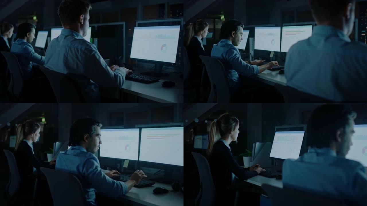 深夜在现代办公室: 一排雄心勃勃的商人和女商人在台式计算机上工作，一起完成重要的项目。