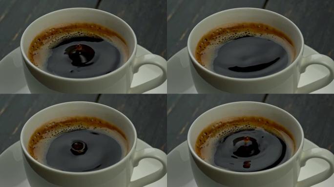 咖啡滴落入咖啡杯中，上面覆盖着开胃的泡沫。慢动作