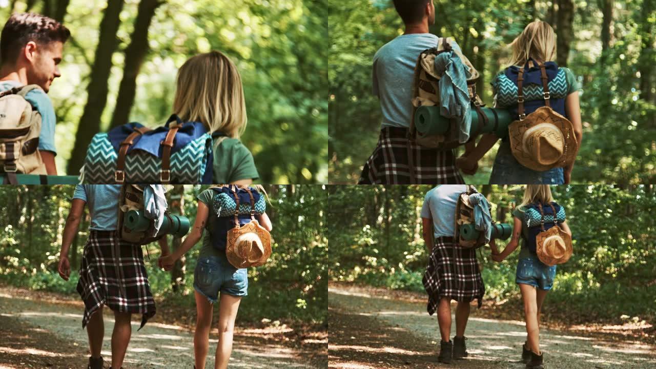 夫妇在森林徒步旅行时牵手
