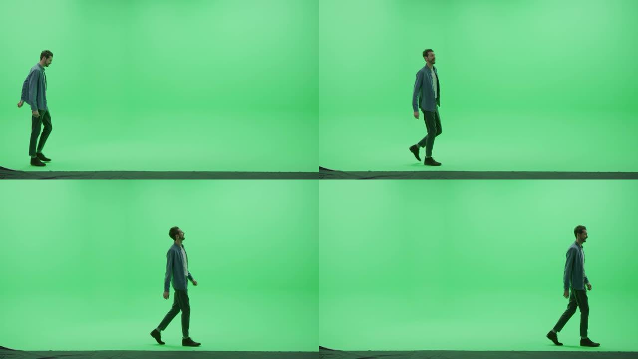绿屏色键工作室: 穿着休闲服的坚强英俊的微笑男人在房间里从左到右跳舞。侧视图摄像机拍摄