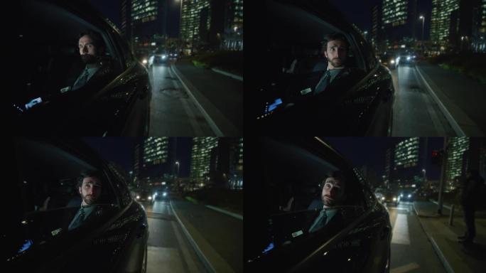 慢动作的年轻英俊的商人在一个现代汽车旅行期间与一个司机在市中心的夜晚