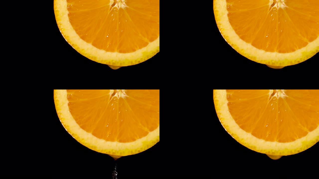 实时: 黑色橙色切片上的水滴