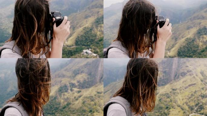 特写快乐的年轻记者女人背着背包和飞舞的头发拍摄斯里兰卡史诗般的山景