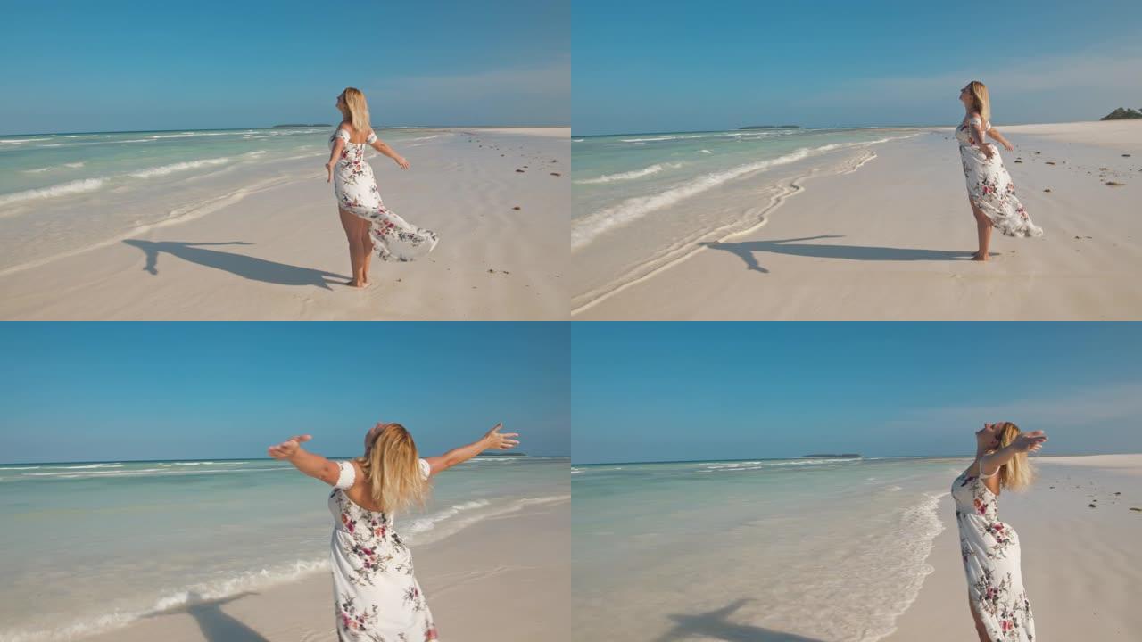 穿着长裙的SLO MO女人在沙滩上享受新鲜空气