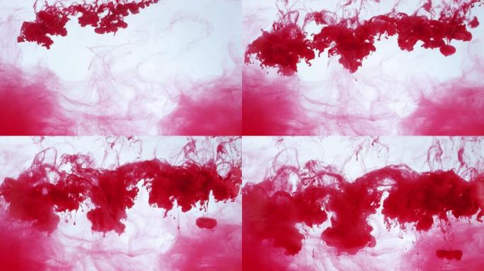 红色油漆滴落在透明液体中