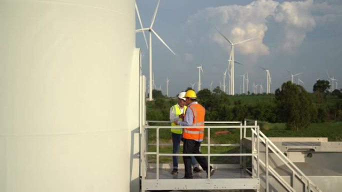 4k分辨率亚洲风力涡轮机机械工程师团队在风力涡轮机领域，风力发电和替代能源concep由笔记本电脑工