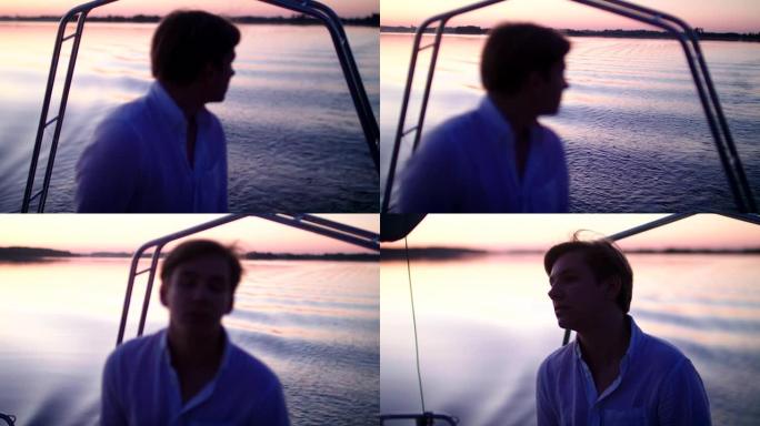 湖上浪漫的日落。享受帆船运动的年轻人