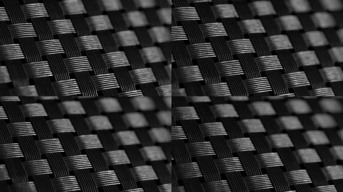 塑料织物背景。特写镜头碳纤维材料黑色质感