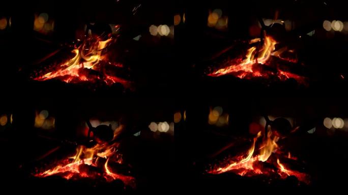 孤独的人在河边燃烧篝火。烘焙晚餐