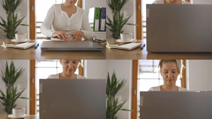 DS女人早上在家使用笔记本电脑工作