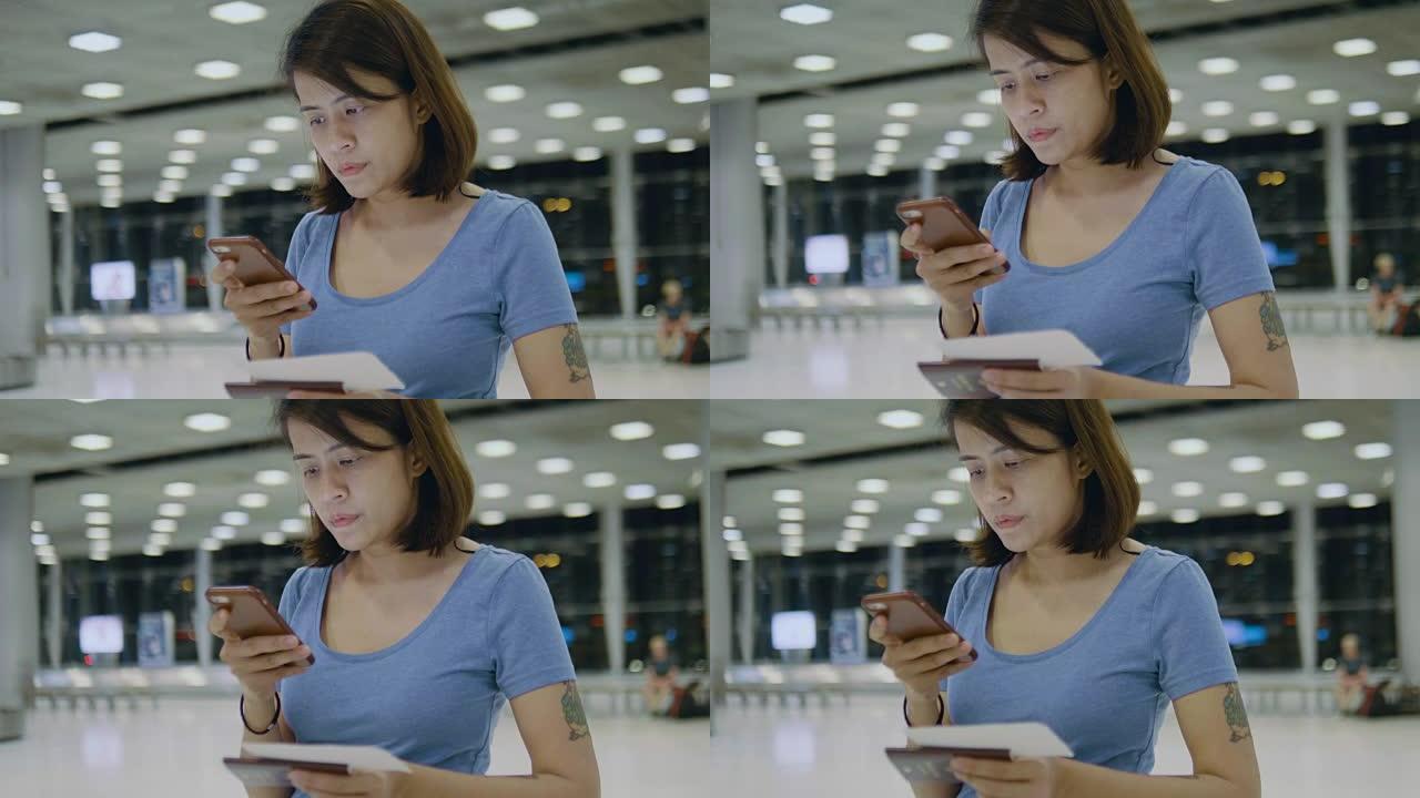 旅游妇女使用电话在机场办理登机手续
