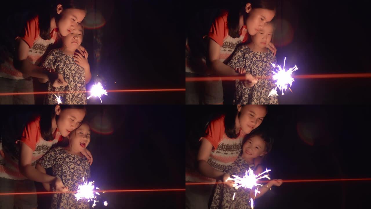 两个快乐的年轻女孩玩火花