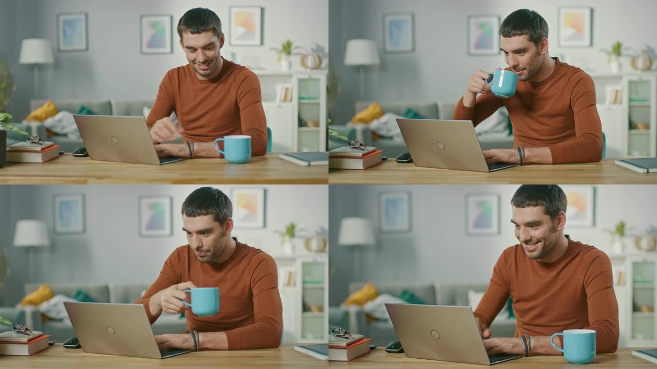 英俊的微笑男人的肖像在笔记本电脑上工作，坐在家里的木桌旁。男子浏览互联网，在他的客厅里在笔记本上工作