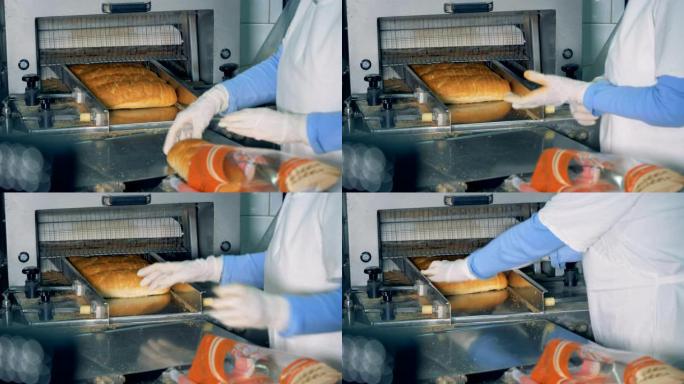 工厂工人切割后将面包放在包装中。4K。