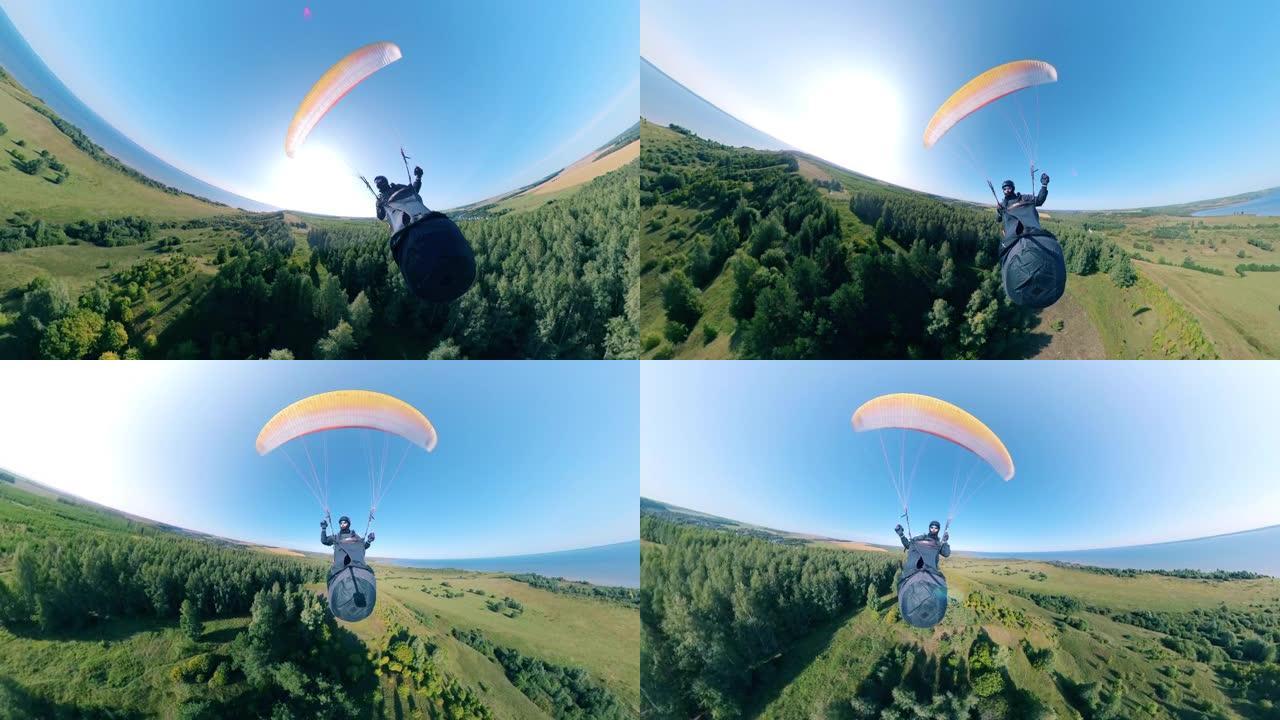 运动员用滑翔伞训练，飞越田野。