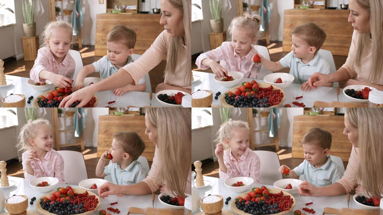 快乐的高加索孩子和妈妈喜欢夏天的浆果
