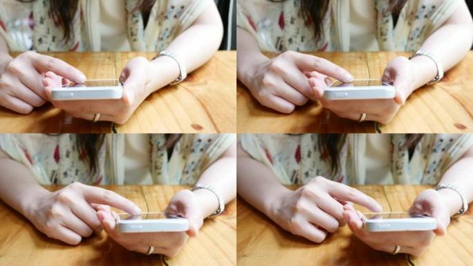 在咖啡馆使用智能手机的特写女人的手