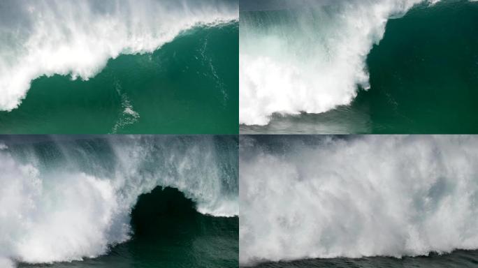 巨大的绿松石色海浪压在海岸上，变成了大量的白色泡沫 (海浮渣)。慢动作镜头