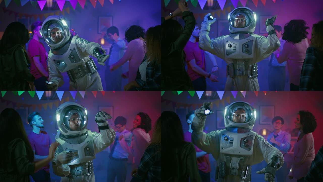 在大学之家的服装派对上: 穿着太空服的有趣家伙跳舞，做时髦时髦的机器人舞蹈现代动作。和他一起美丽的女