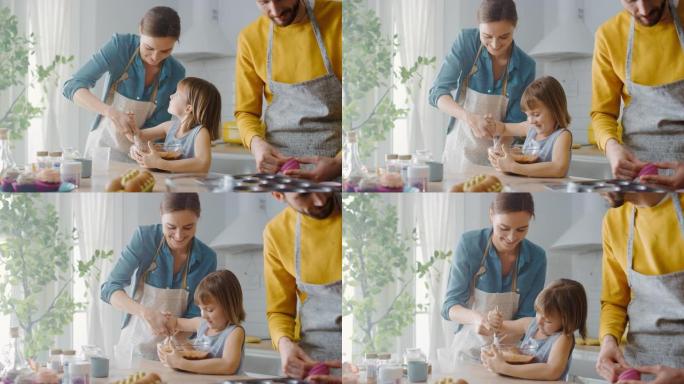 在厨房里: 一家四口一起煮松饼。母亲和女儿将面粉和水混合在一起，为纸杯蛋糕制作面团，父亲和儿子为平底