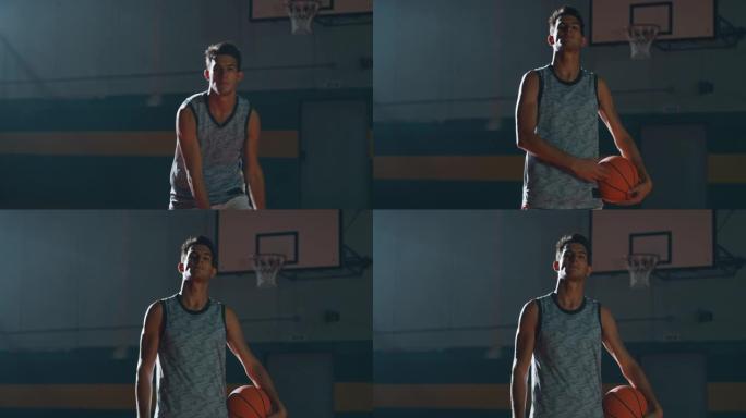一名年轻职业男球员的电影慢动作镜头正在健身房练习篮球锻炼