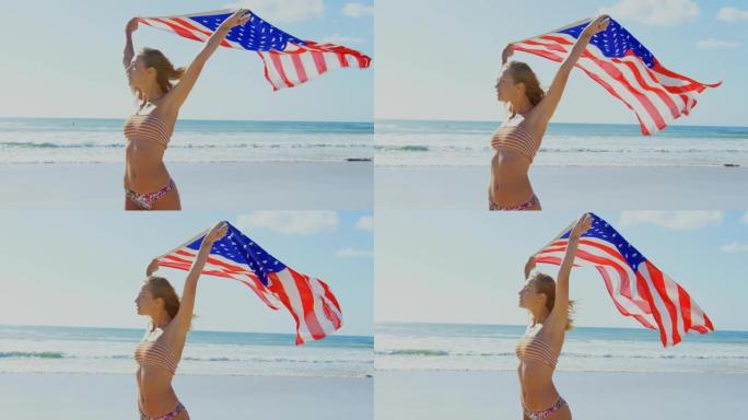 女子在4k海滩上举着美国国旗