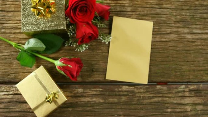 木质表面的红玫瑰、礼品盒和卡片4k