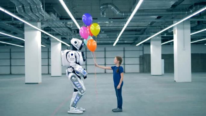 小女孩给机器人气球，侧视图。学校的孩子，教育，科学课的概念。