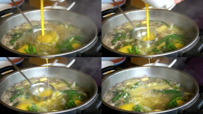 4k镜头沸腾汤火锅搅拌加鸡蛋、沙锅、寿喜烧日式美食概念的场景