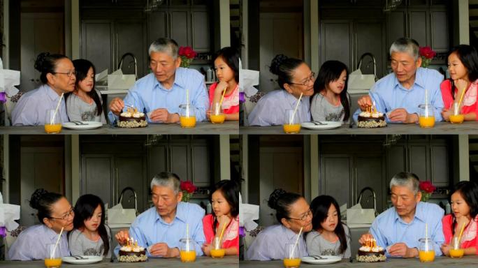 舒适家庭4k中老亚洲祖父闪电生日蛋糕蜡烛的前视图