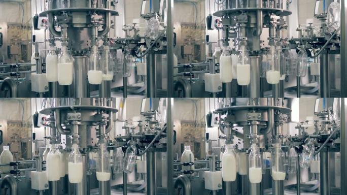 工厂大楼正在将透明瓶子装满牛奶。工业工厂设备灌装塑料瓶