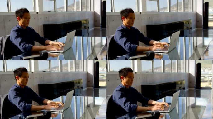 年轻的亚洲商务男性高管在办公室4k笔记本电脑上工作