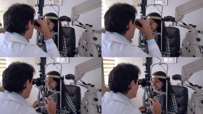 快乐的儿科验光师检查拉丁美洲女孩的眼睛