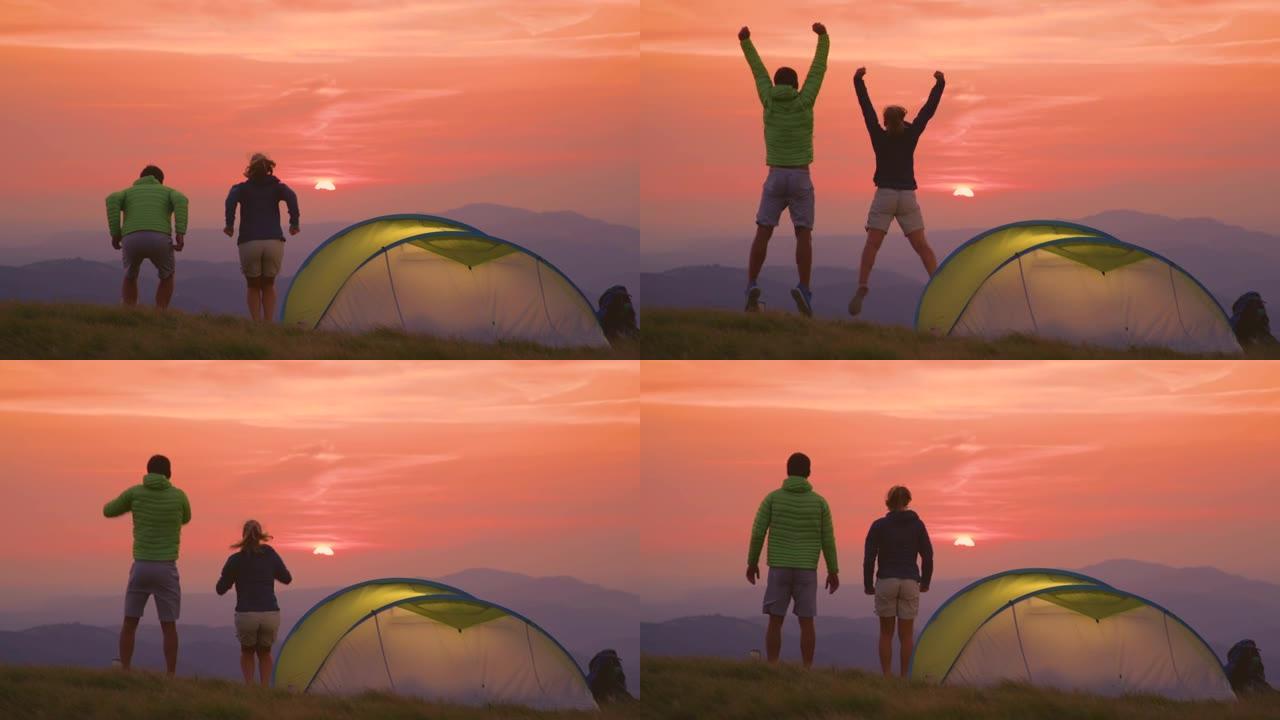 慢动作: 露营者在阿尔卑斯山一个阳光明媚的夜晚跳跃和伸出手臂。