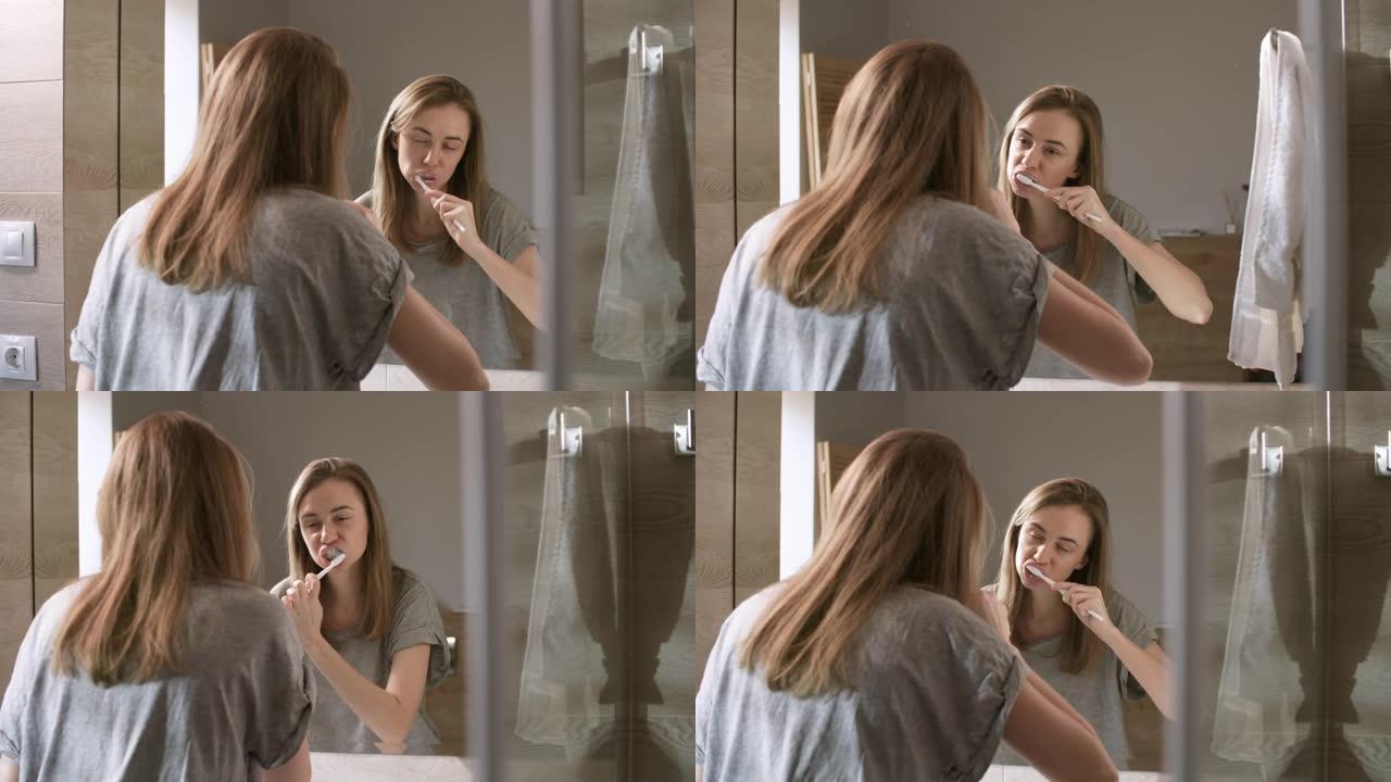 年轻女子在浴室刷牙