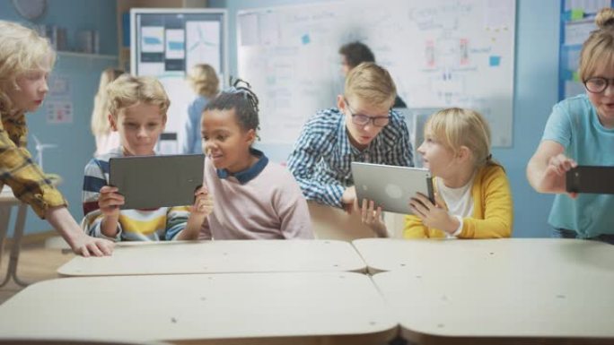 学校计算机科学课: 学童使用带有增强现实软件的数字平板电脑和智能手机，他们兴奋不已，充满了惊奇。孩子