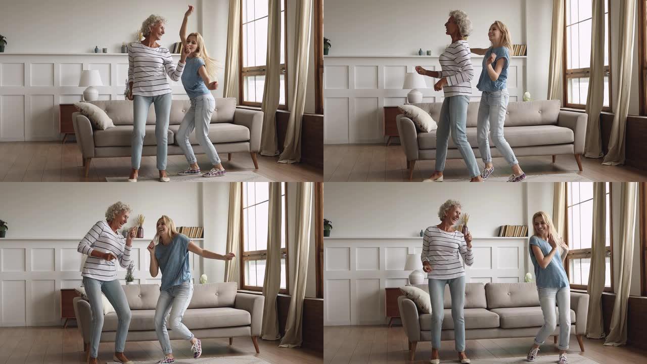 兴奋的老年成熟女人在家与成年女儿跳舞。