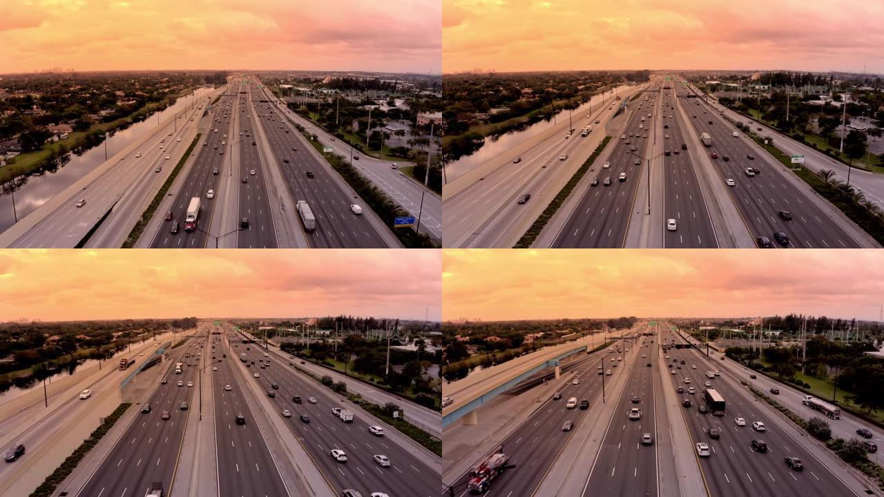 美国佛罗里达州迈阿密日落时，WS鸟瞰图汽车沿着高速公路行驶