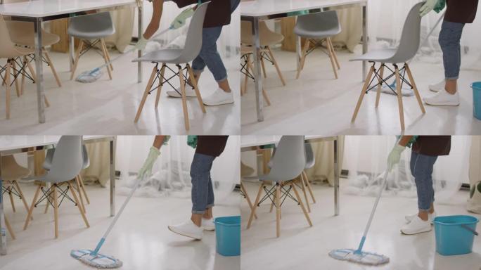 面目全非的女人用拖把洗地板