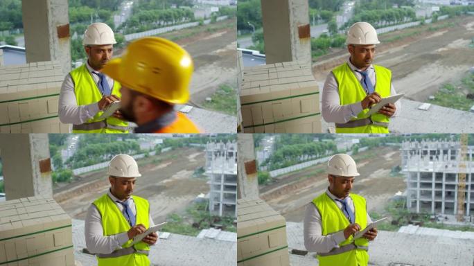 阿拉伯建筑工地主管用平板电脑做笔记