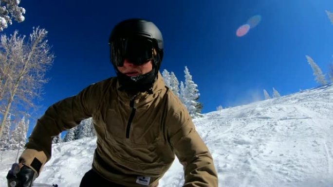 POV年轻人在阳光明媚的冬日滑雪滑下粉末跑步