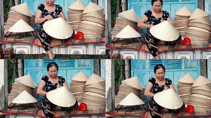 越南坎托省Ap Thoi Phuoc村的旧传统房子里制作传统越南帽子的4k镜头，传统艺术家概念